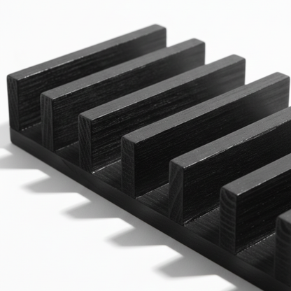 ARTSN black charred wooden rack with horizontal fins on a white background