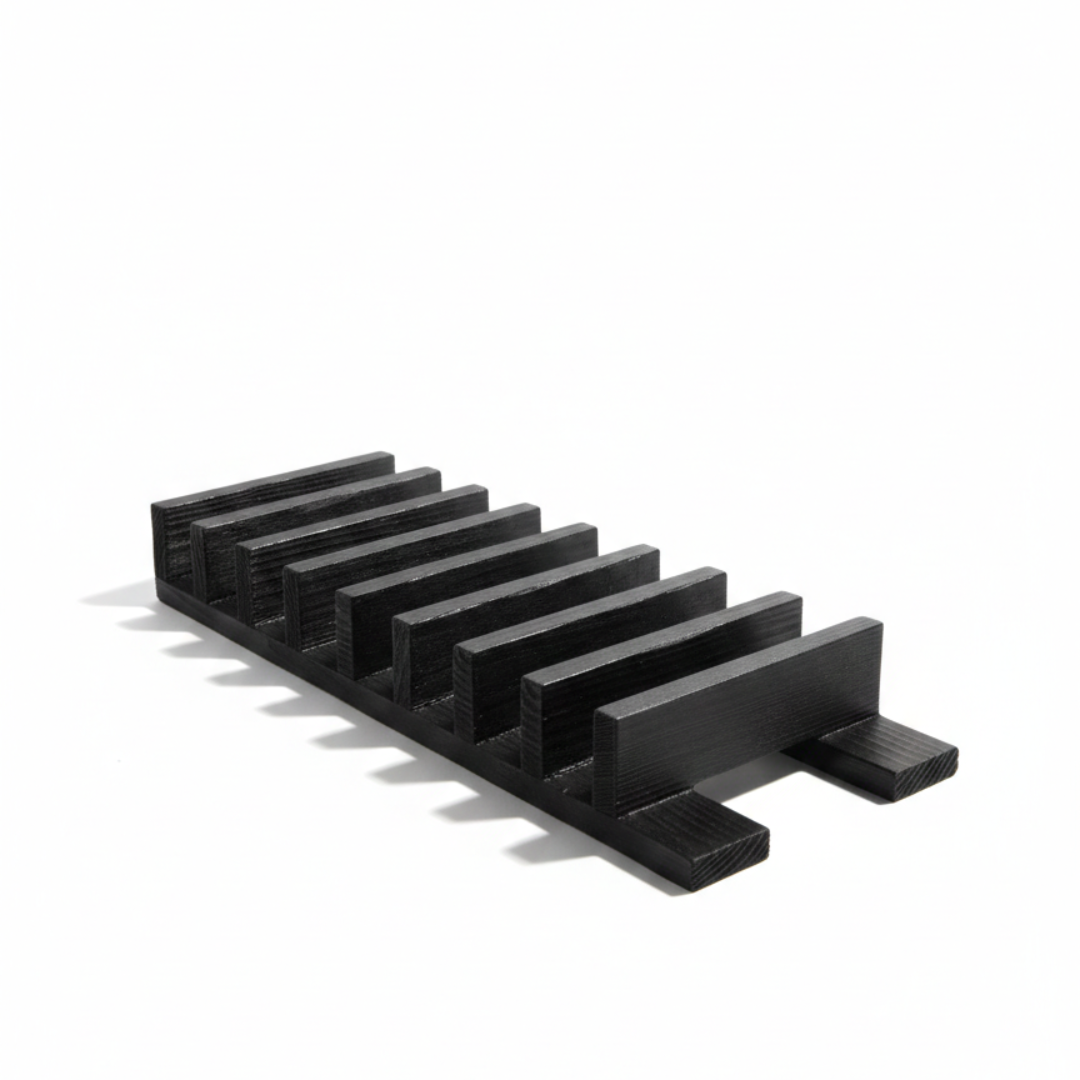 ARTSN black charred wooden rack with slots for knives on a white background