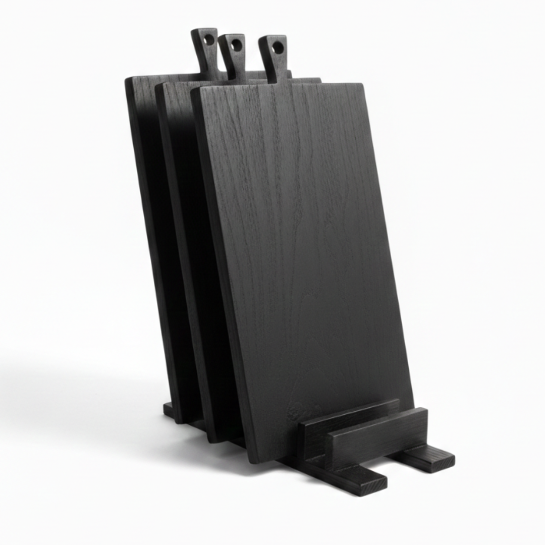 ARTSN set of black charred wooden cutting boards with handles in matching stand on white background